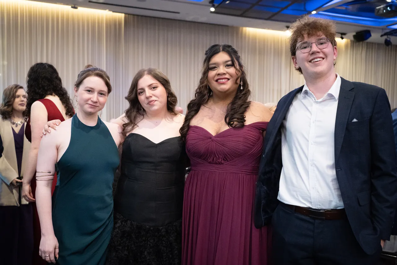 A group of upper secondary students from the Overnewton Class of 2025, smiling directly at the camera in celebration as they gather at their Valedictory Dinner event held at Hyatt Place, Essendon Fields.