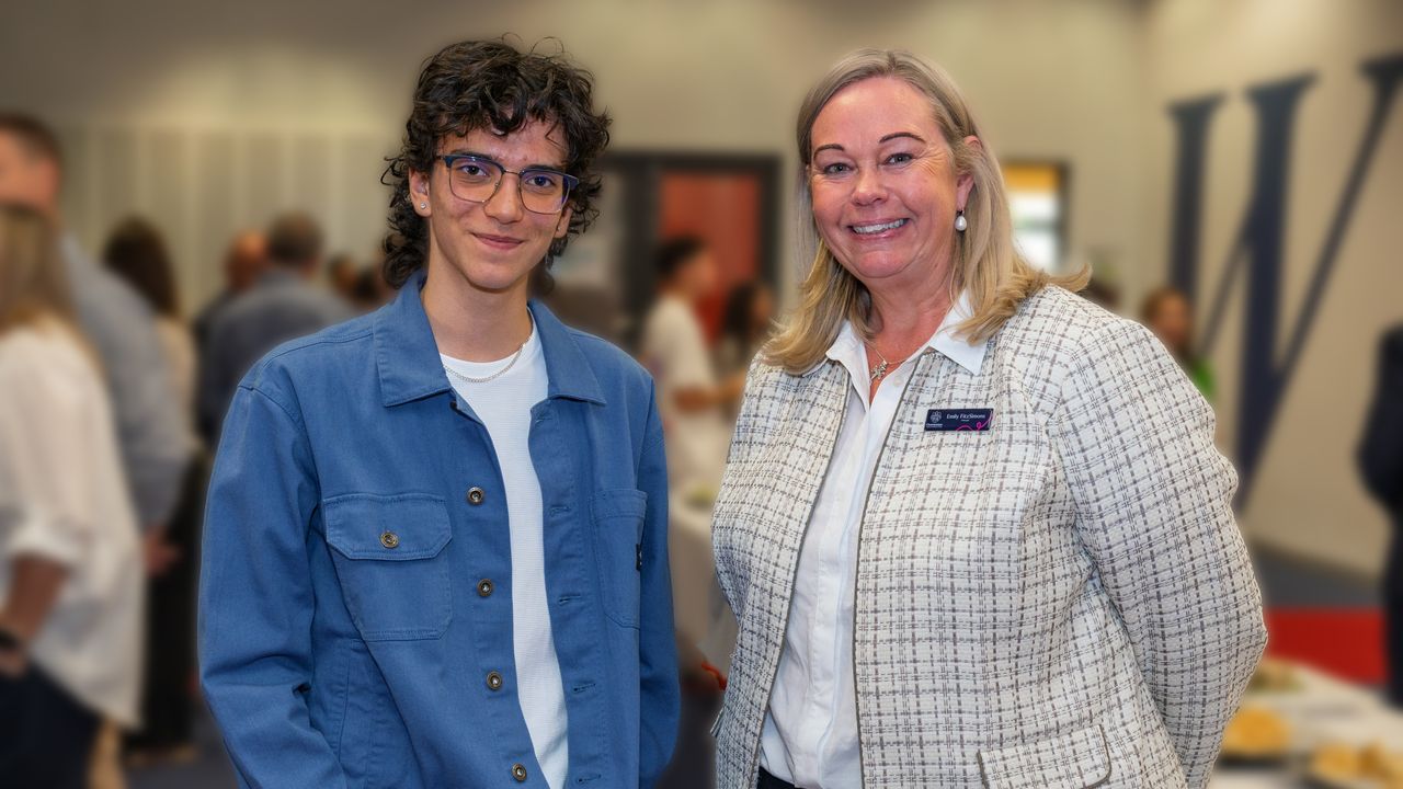 Principal proudly standing next to the 2024 College Dux at Overnewton, celebrating academic excellence and student achievement.