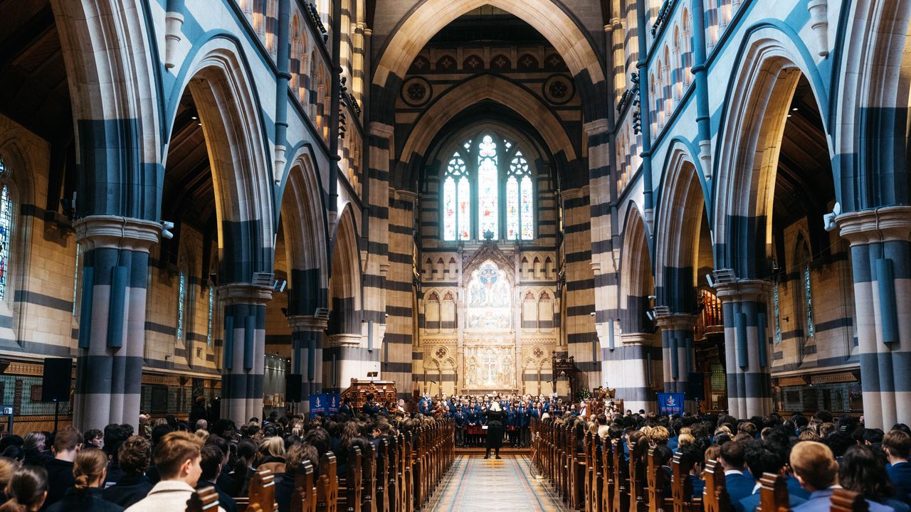 Impressive down-the-aisle shot of students seated in St Paul’s Cathedral during the Founders Day Service, with soaring archways, stained glass windows, and the grand altar creating a breathtaking backdrop.