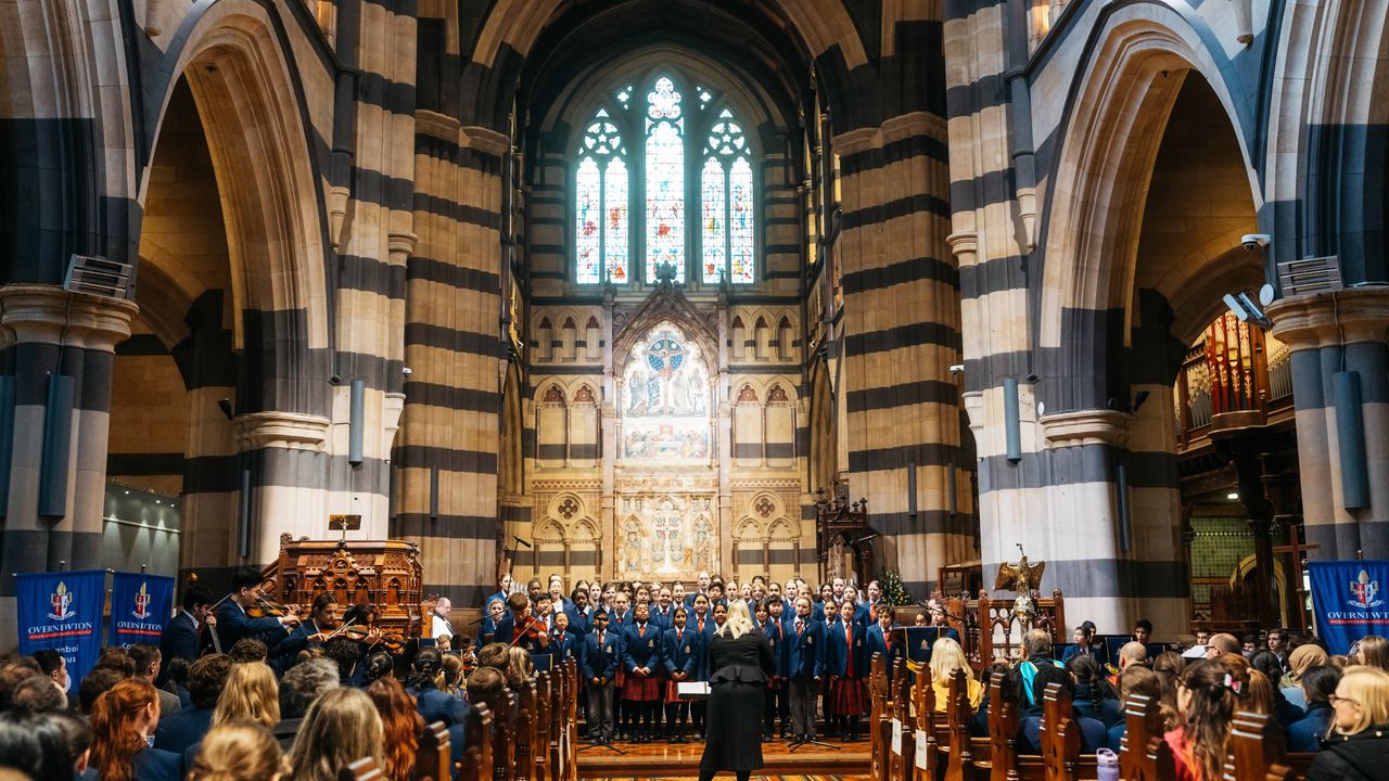 Wide internal shot of St Paul’s Cathedral during the Founders Day Service, featuring the Overnewton choir and musical ensemble performing as part of the service in the grand cathedral setting.