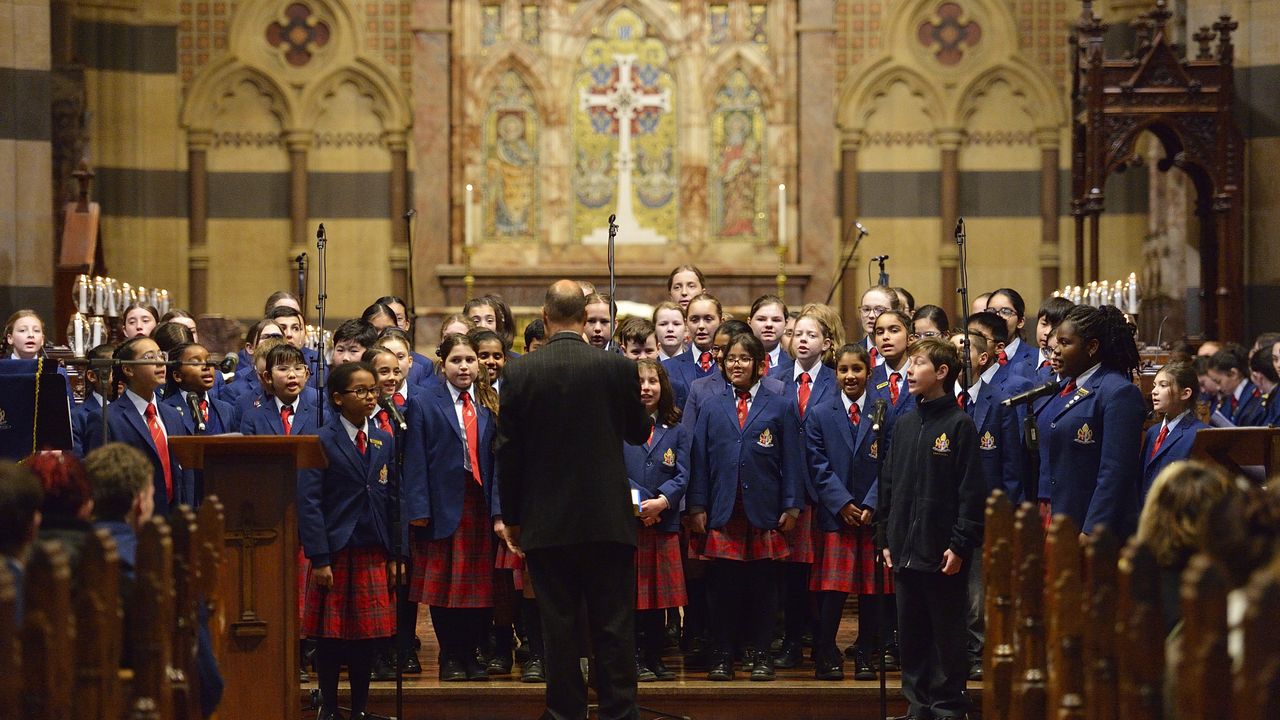 Wide internal shot of St Paul’s Cathedral during the Founders Day Service, featuring the Overnewton choir and musical ensemble performing as part of the service in the grand cathedral setting.