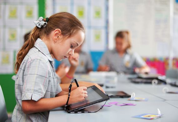 student on ipad with pen