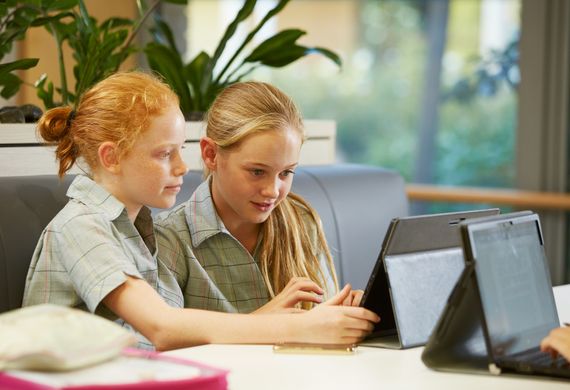 two students using iPad together