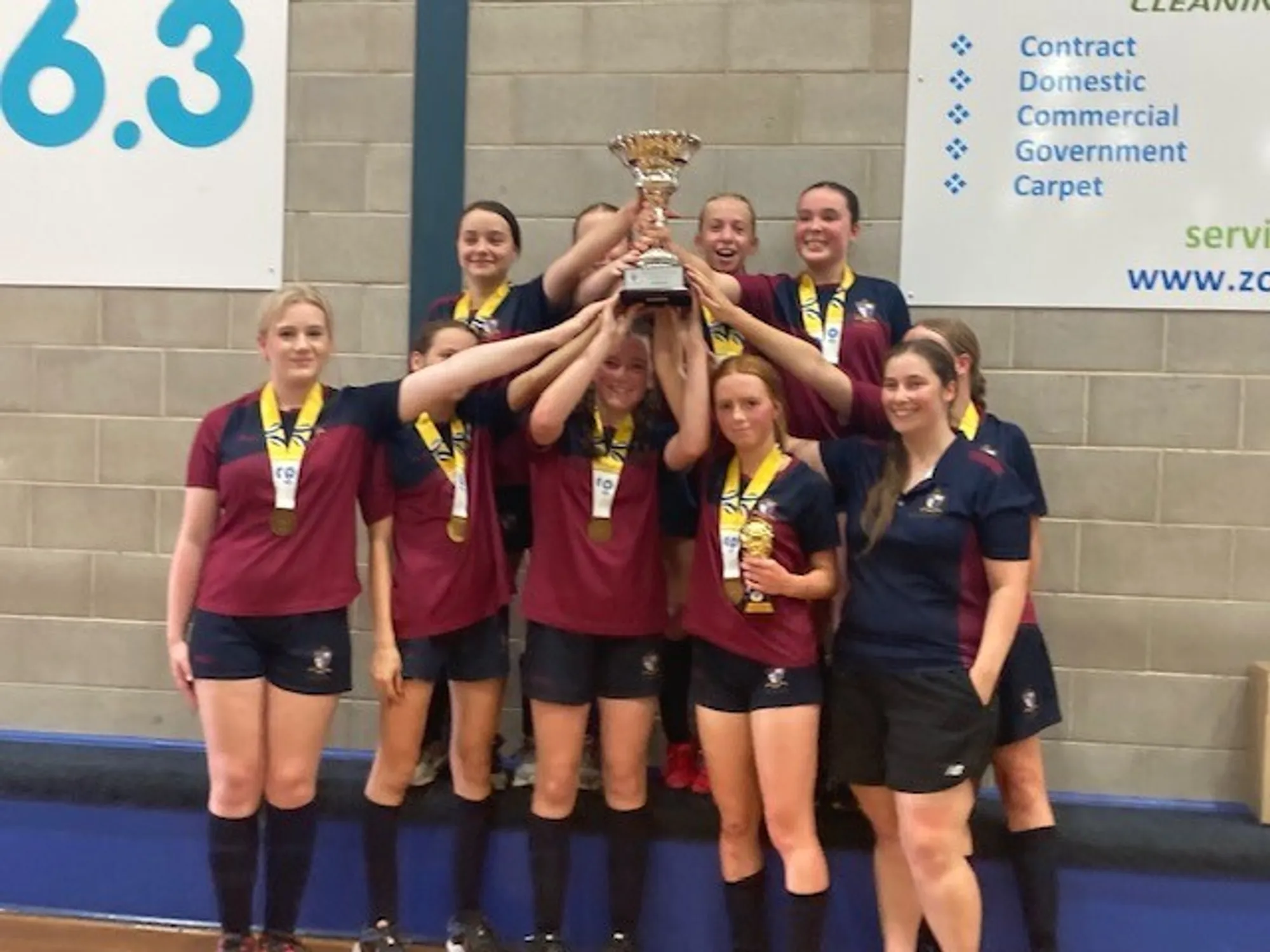 U14 Division 2 Raptors holding their winning trophy aloft.