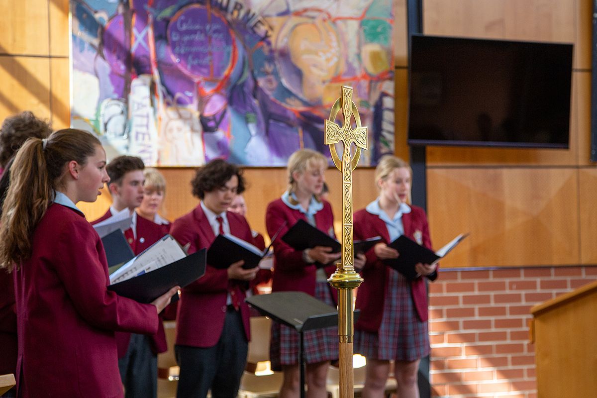Students singing in the chapel
