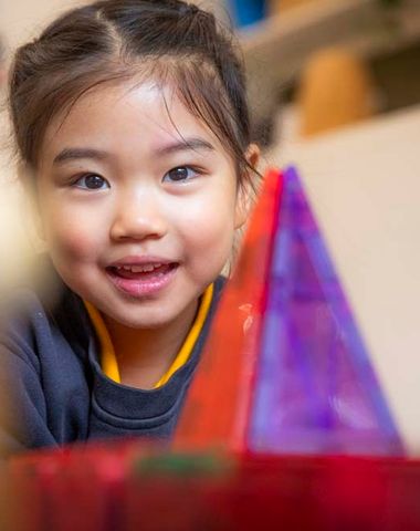 A kindergarten student smiling in the Early Learning Centre at Ruyton Girls' School