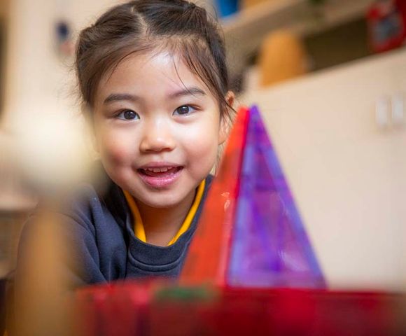 A kindergarten student smiling in the Early Learning Centre at Ruyton Girls' School