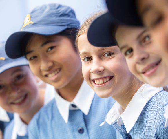 A group of Junior School students from Ruyton Girls' School smiling at the camera