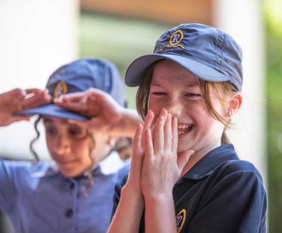 A Junior School student laughing in the playground at Ruyton Girls' School