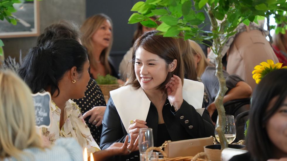 A mother laughing and enjoying lunch at a Ruyton Girls' School function for parents