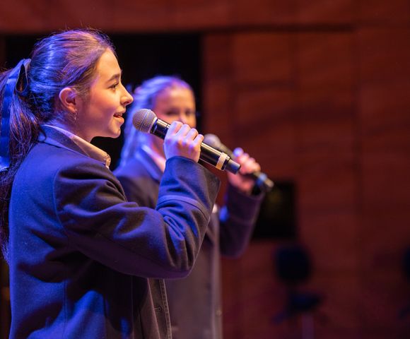 A Senior School student singing into the microphone at Ruyton Girls' School