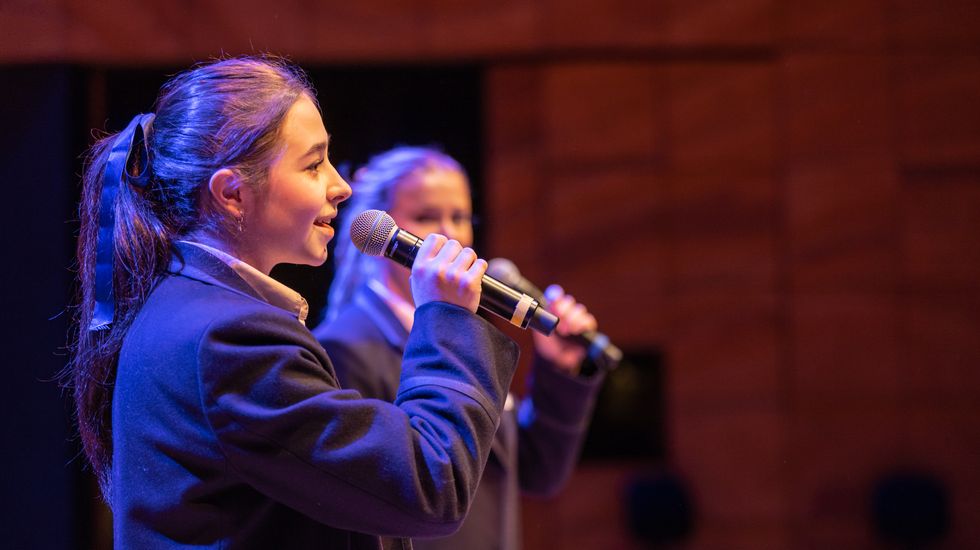 A Senior School student singing into the microphone at Ruyton Girls' School