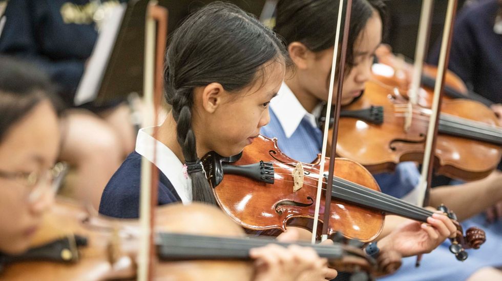 A group of students playing violin in the orchestra at Ruyton Girls' School