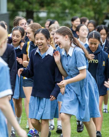 Students laughing with each other on the Oval.