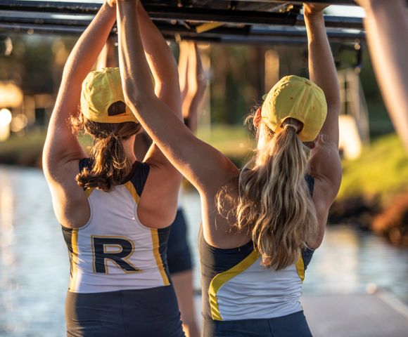 Ruyton Rowers carrying a rowing boat above their heads.