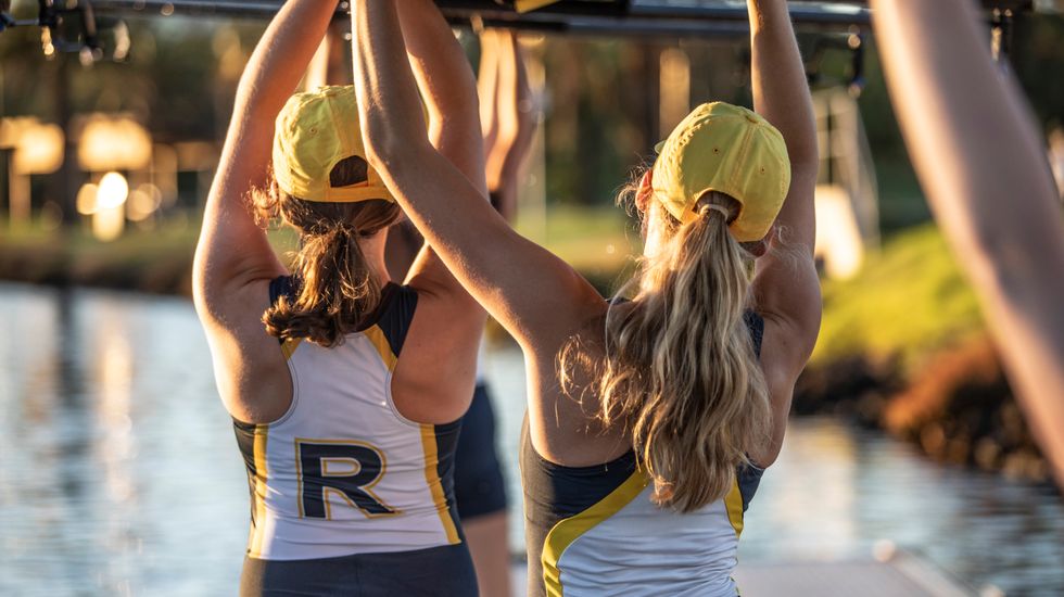 Ruyton Rowers carrying a rowing boat above their heads.