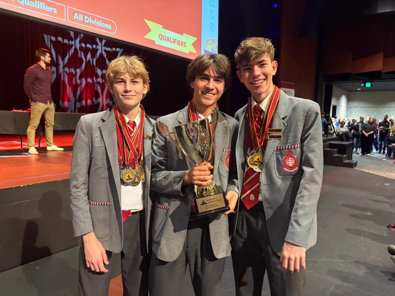 Students holding a trophy and medals