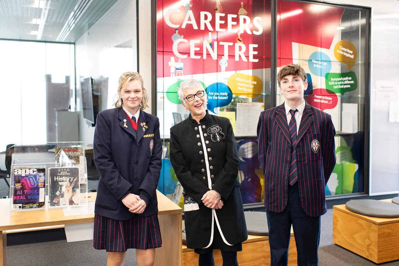 Two St Michael's Grammar School students and a staff member pose together outside the school's Careers Centre.