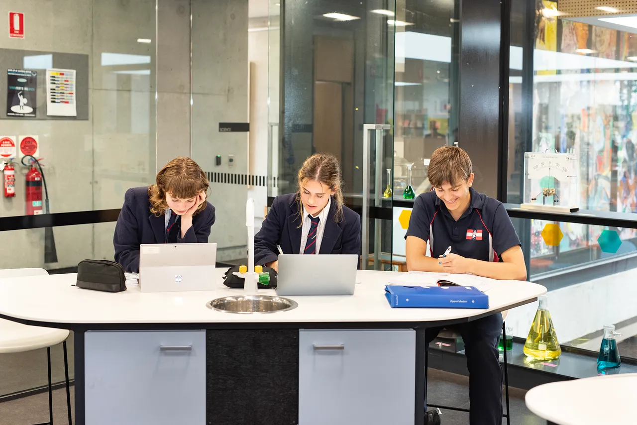 St Michael's Grammar School students collaborating on Microsoft Surface devices in a classroom, supported by the school's Microsoft Lighthouse School program.