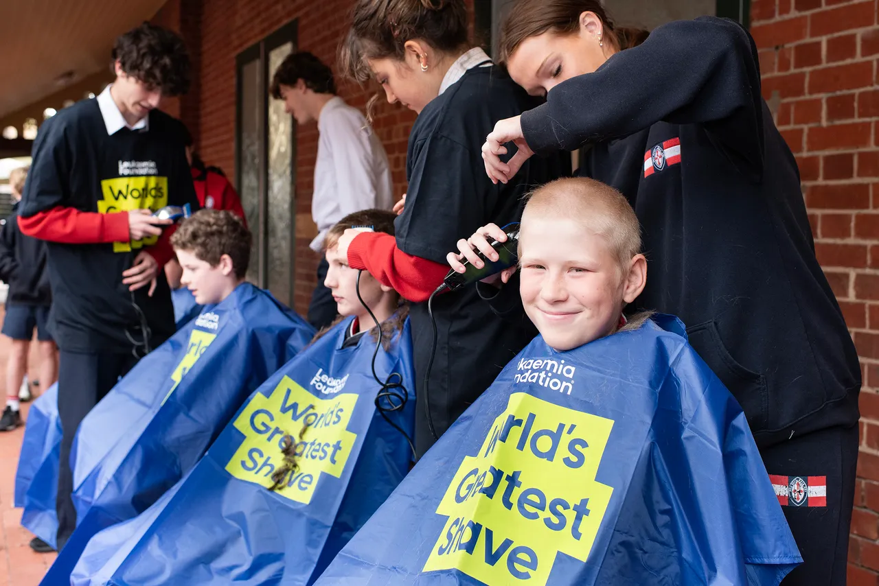 A St Michael's Grammar School student has their head shaved during the World's Greatest Shave fundraiser event at school.