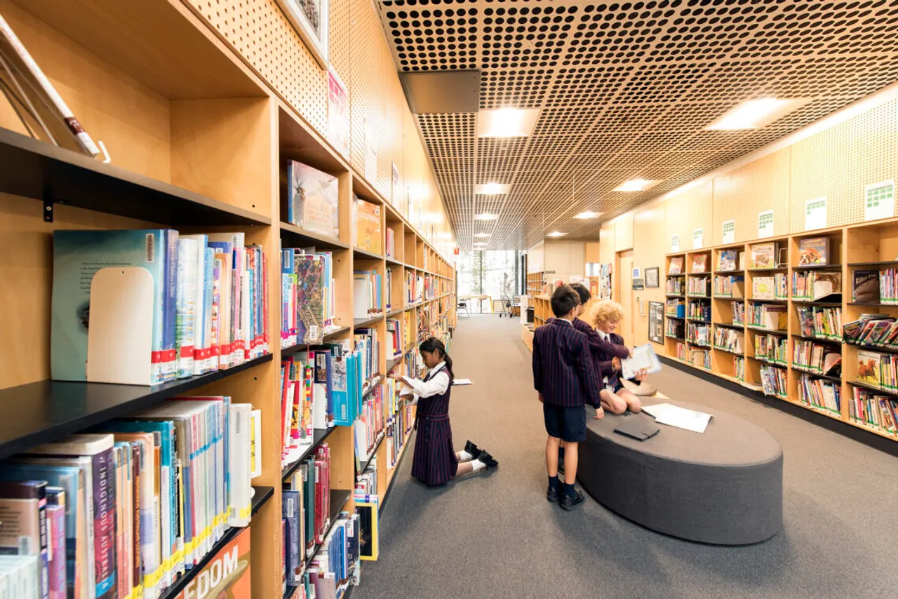 St Michael's Grammar School senior students browse and read among the bookshelves in the school library.