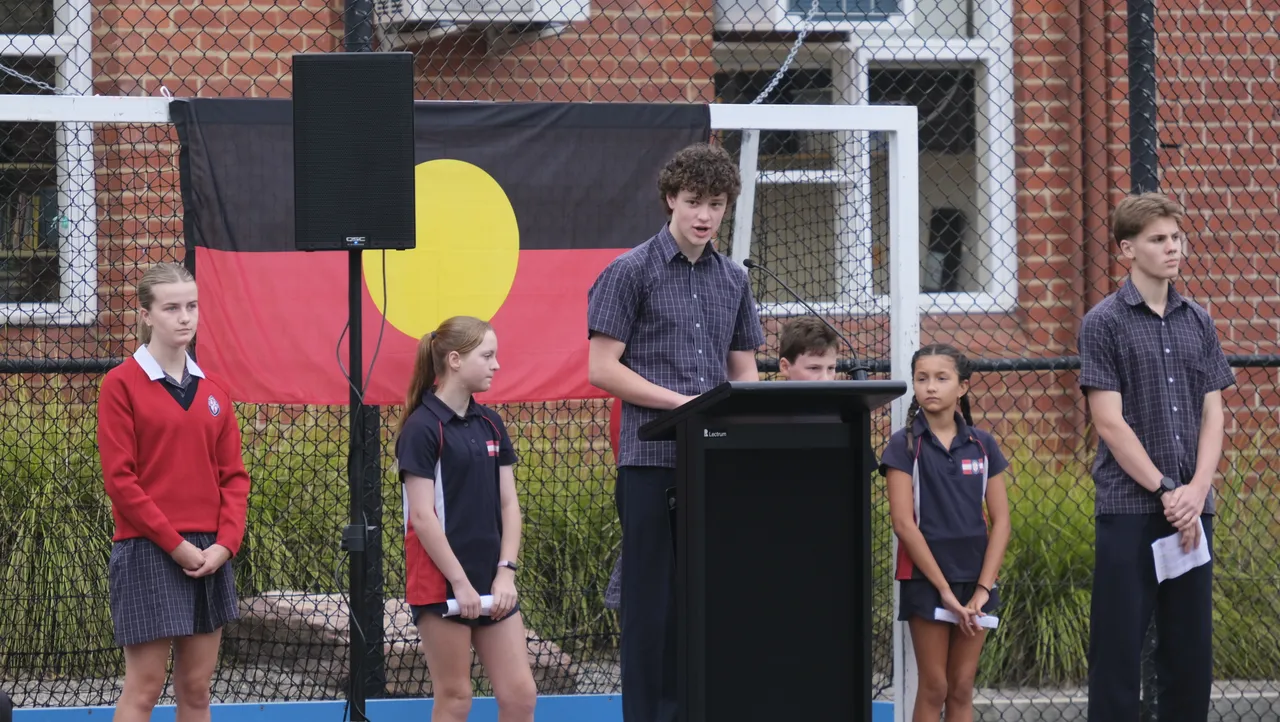Student giving an Acknowledgment of Country before starting a St Michael's school event.