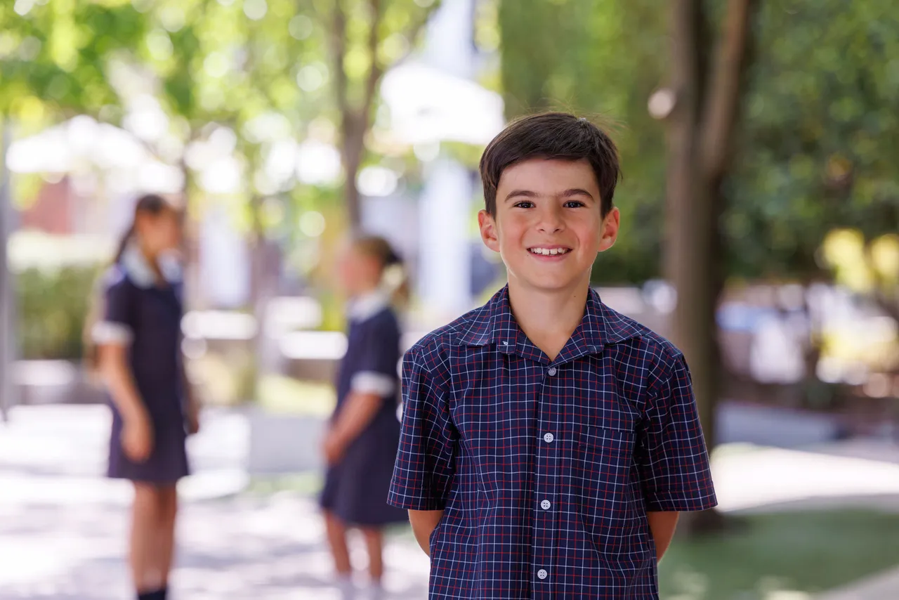 St Michael's student (boy) smiles wide at the camera