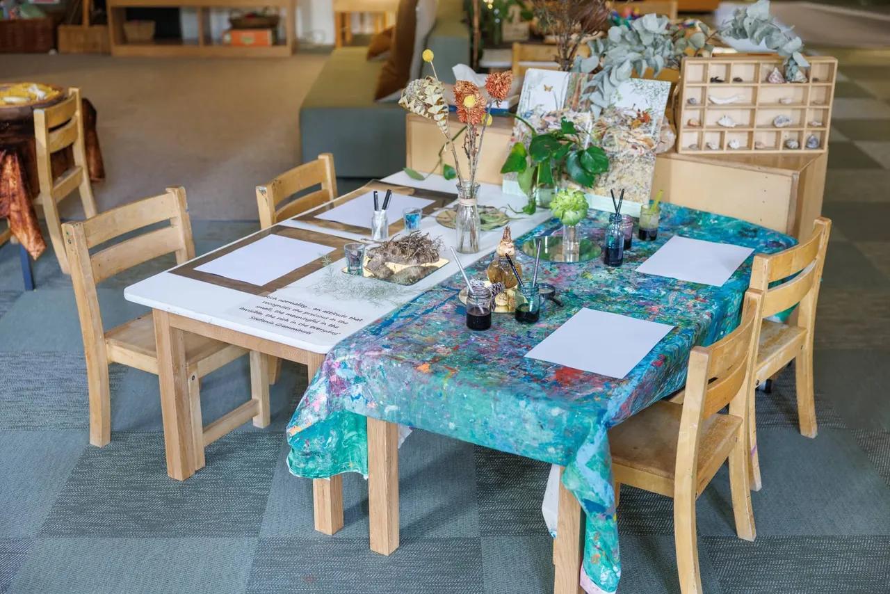 A beautifully prepared drawing provocation table in the St Michael's Grammar School ELC, set with blank paper, ink, natural specimens and fresh flowers to inspire mark-making and observation.