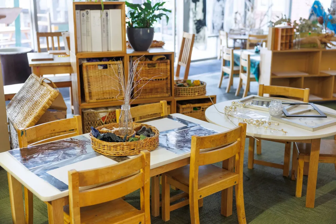 The interior of the St Michael's Grammar School ELC, showing a calm, thoughtfully arranged learning environment with natural materials, wicker baskets and child-sized furniture.