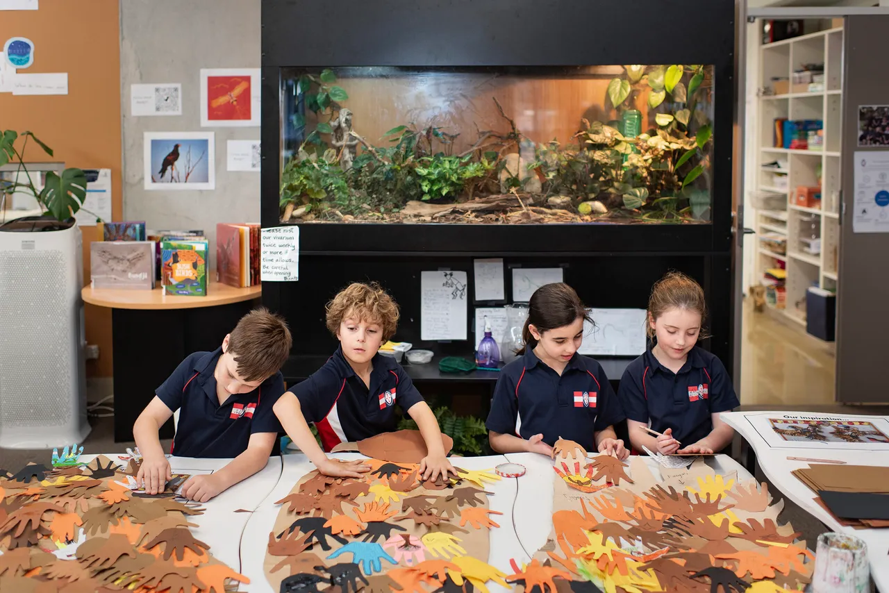 Students creating artwork in class