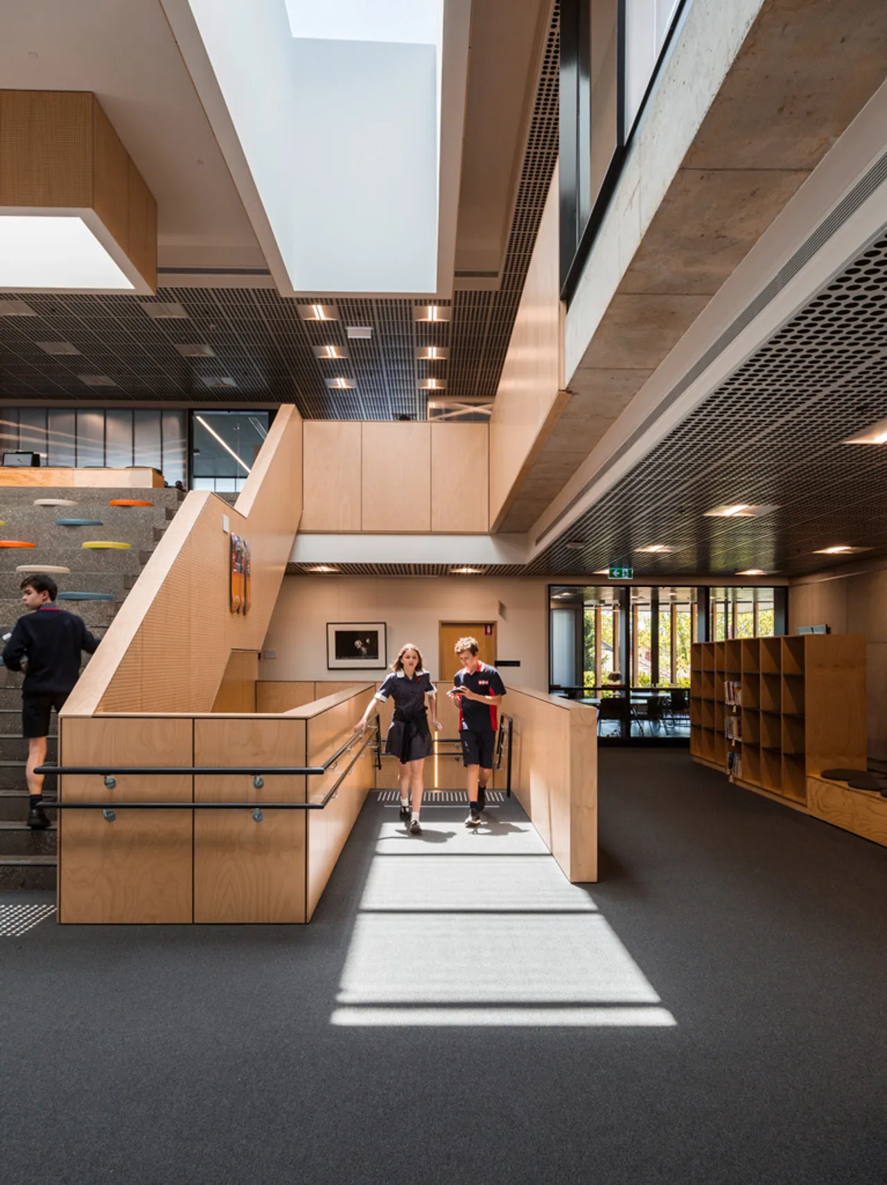 Stairway with students walking inside The Gipson Commons
