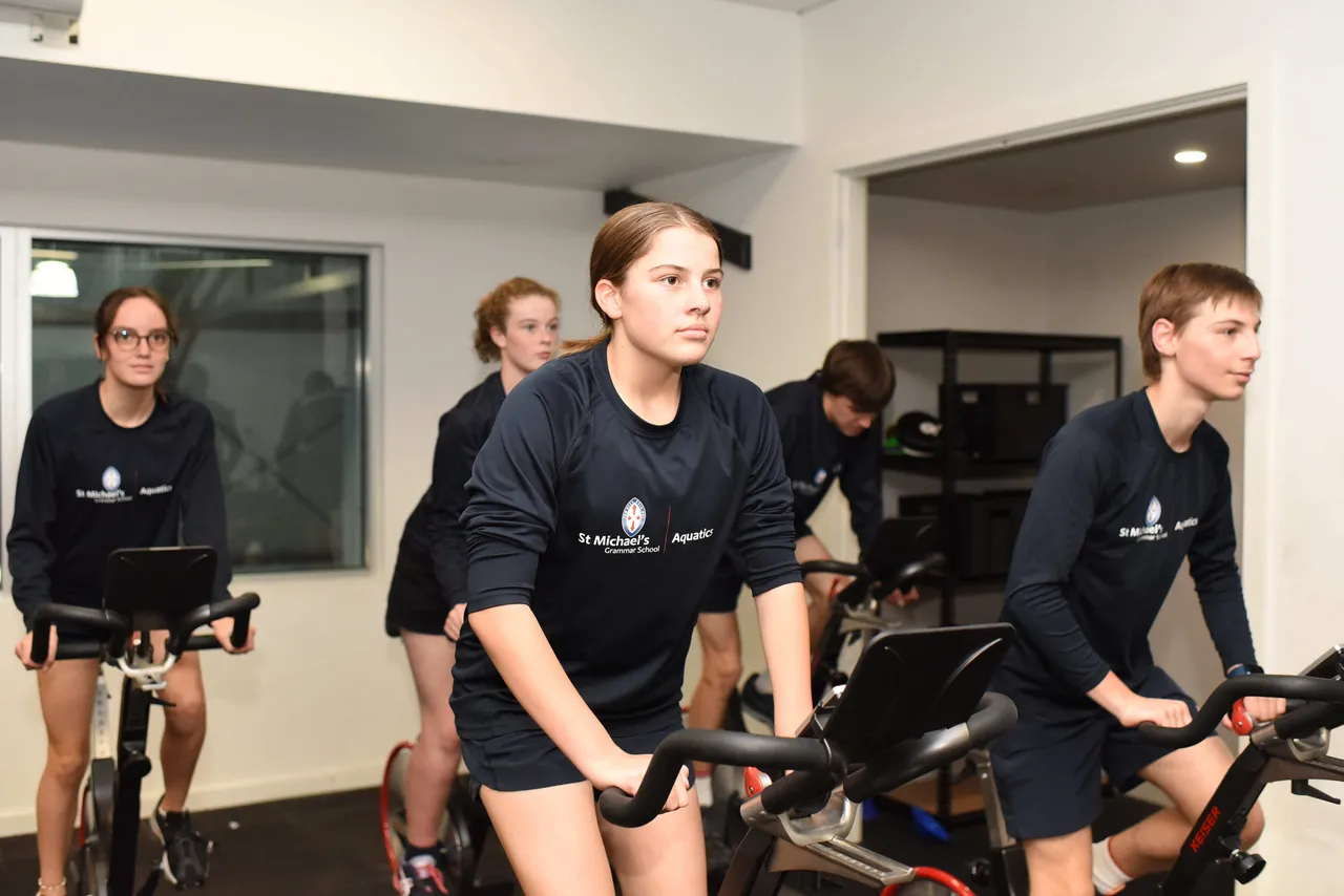St Michael's Grammar School students use exercise bikes during a fitness session in the school's gymnasium.