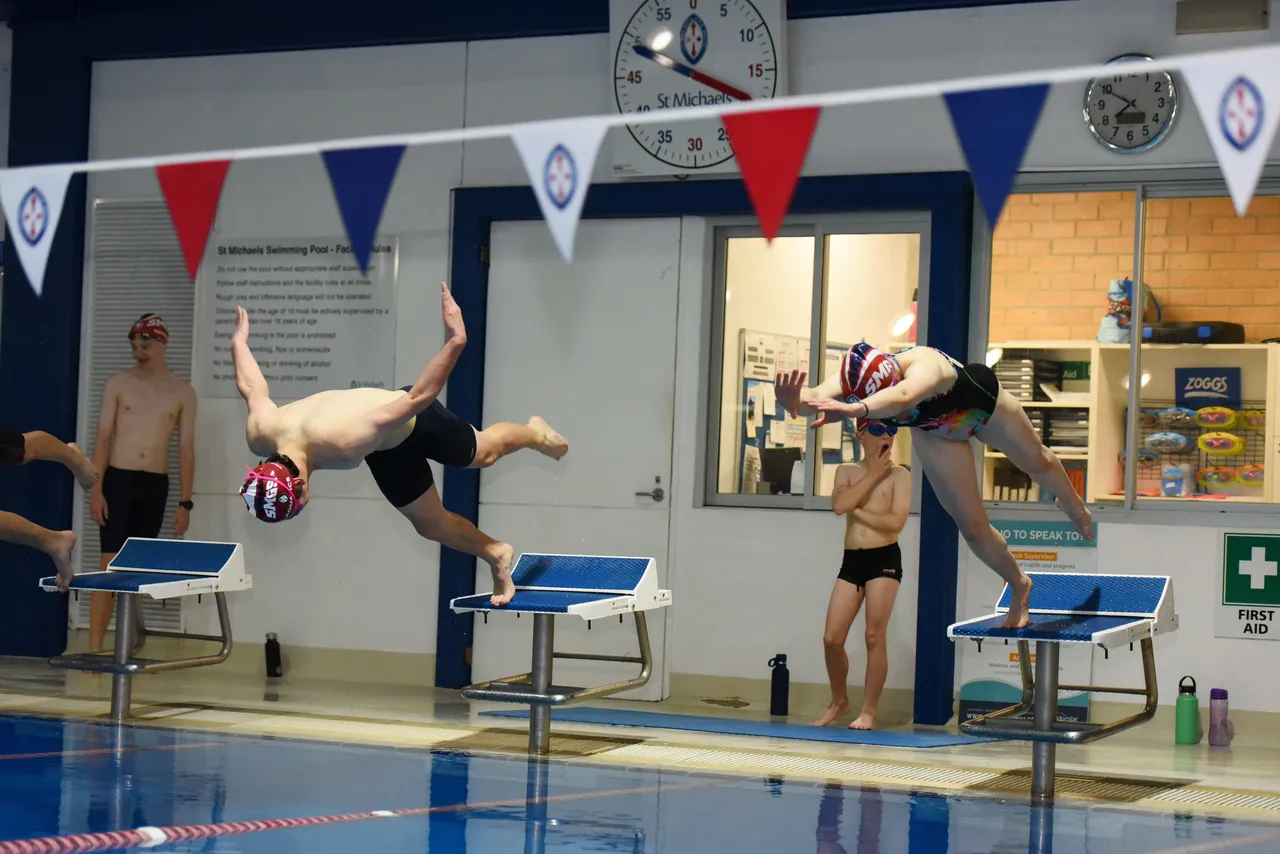 St Michael's Grammar School students swimming laps in the school's indoor heated six-lane pool during squad training.