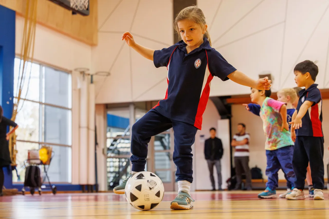St Michael's Grammar School ELC and Prep students participating in the Soccer Clinic Extended Tuition program, practising skills on the school grounds.