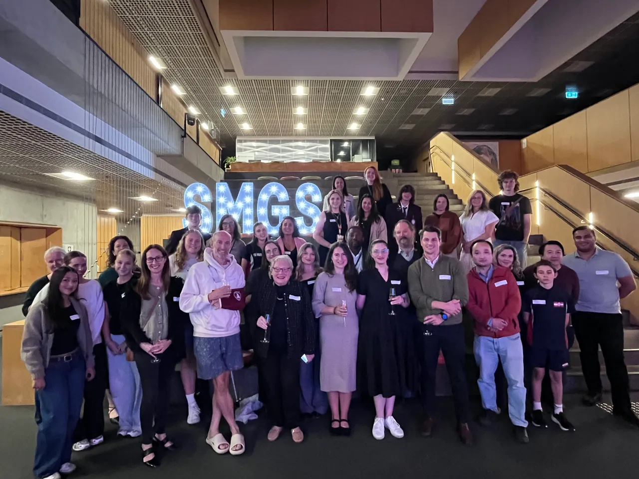 Group photo of all Old Michaelians and current staff who attended a Health networking event in the Gipson Common's Atrium.