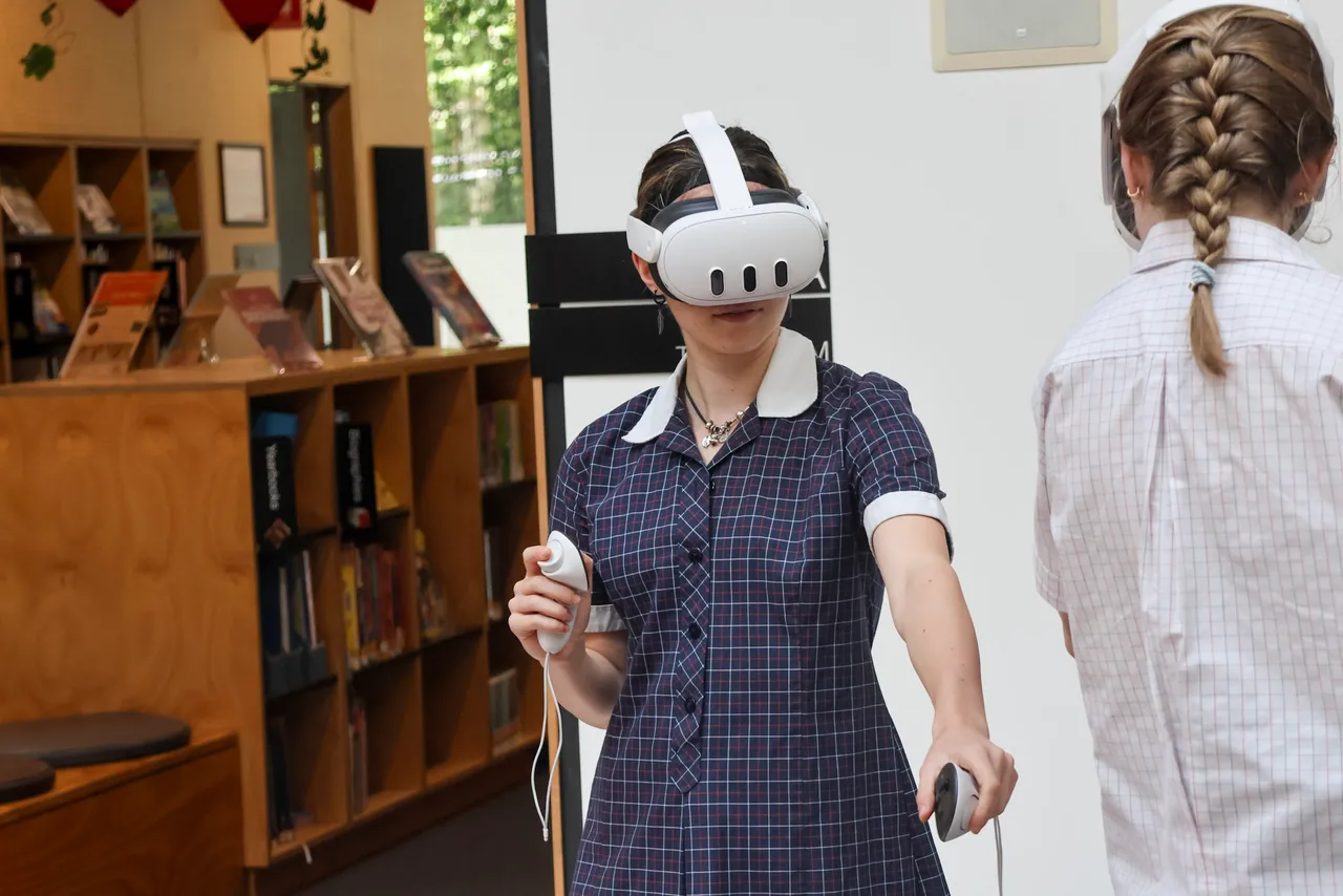 a student simulates driving in a car using a set of vr goggles