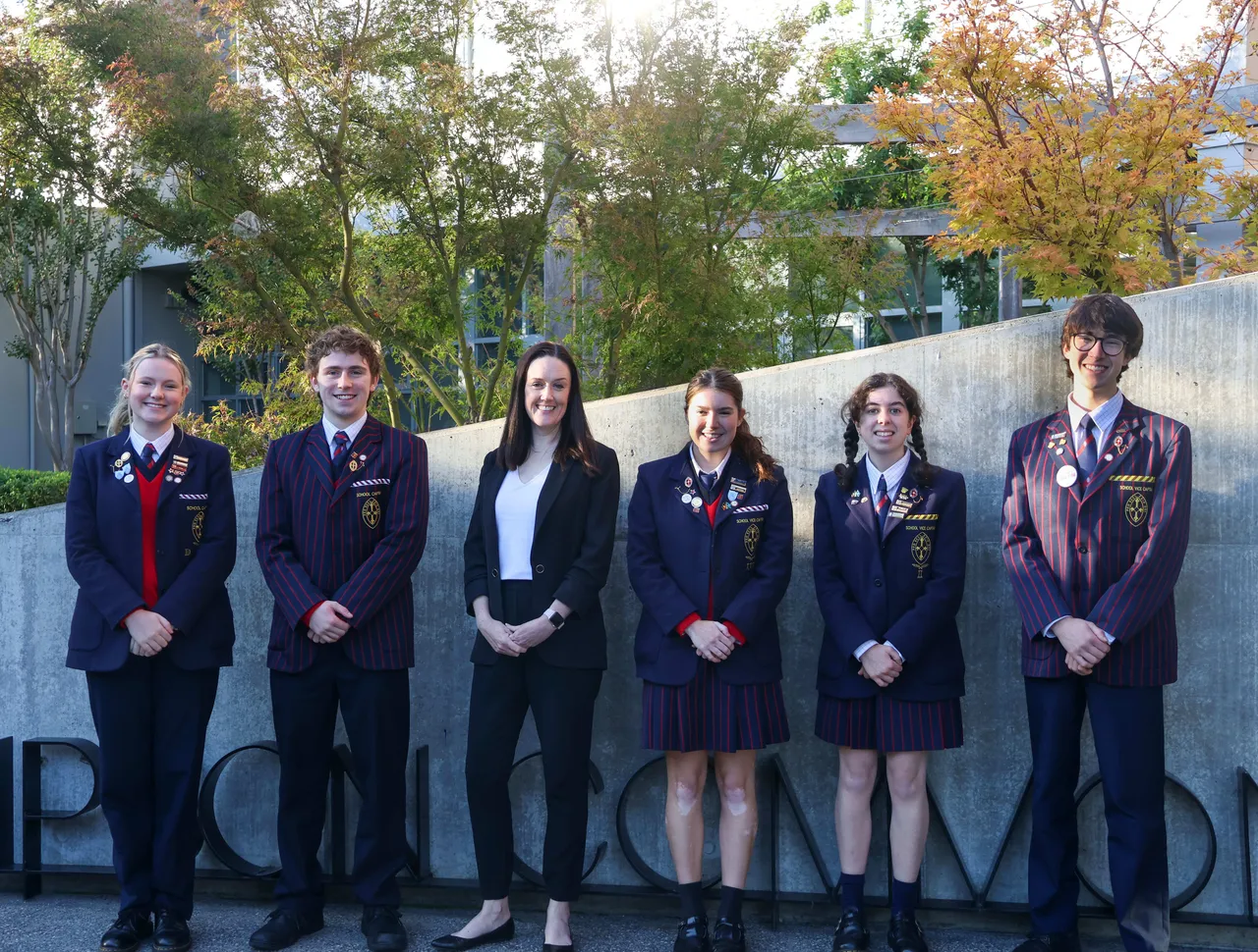 Year 12 leaders pose with our head of the senior school out front of our senior school building.