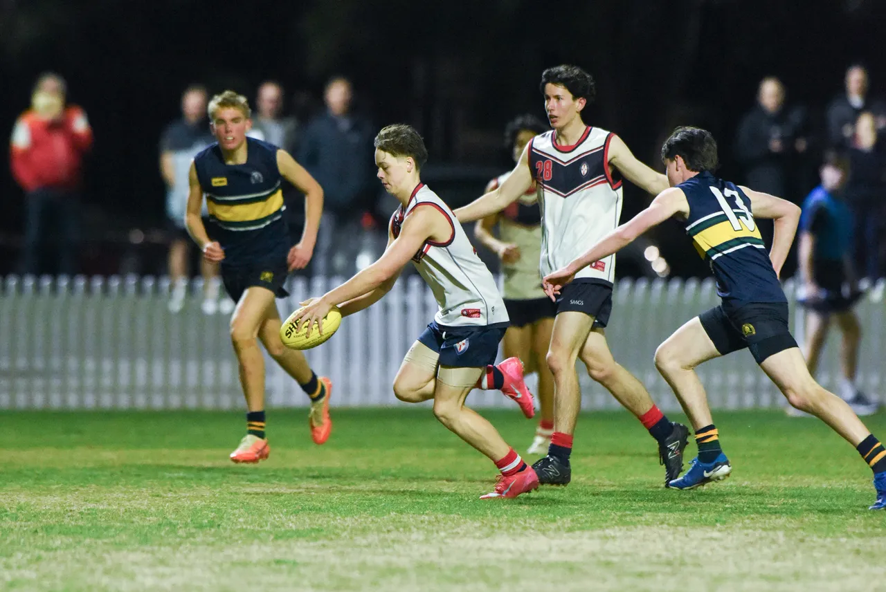 St Michael's boys footy team play against ACS school.