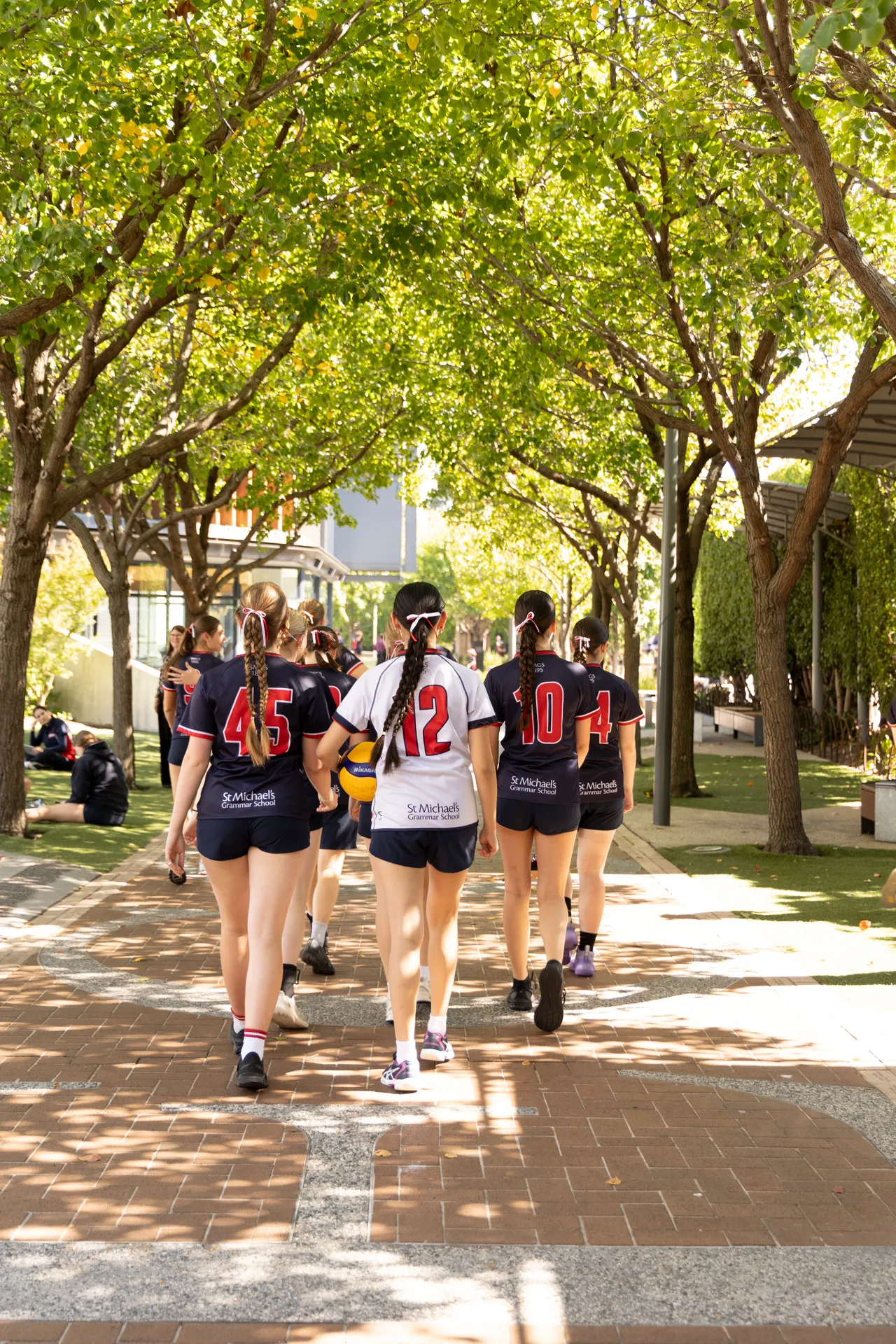 St Michael's Girls netball team walk together through Coleman Walk.