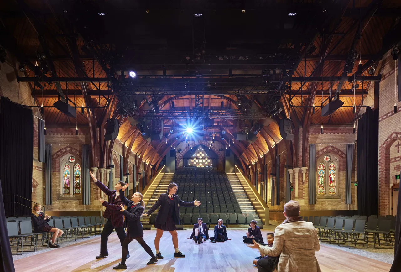 St Michael's Grammar School students rehearse on the stage of a grand heritage theatre venue during a performing arts production.
