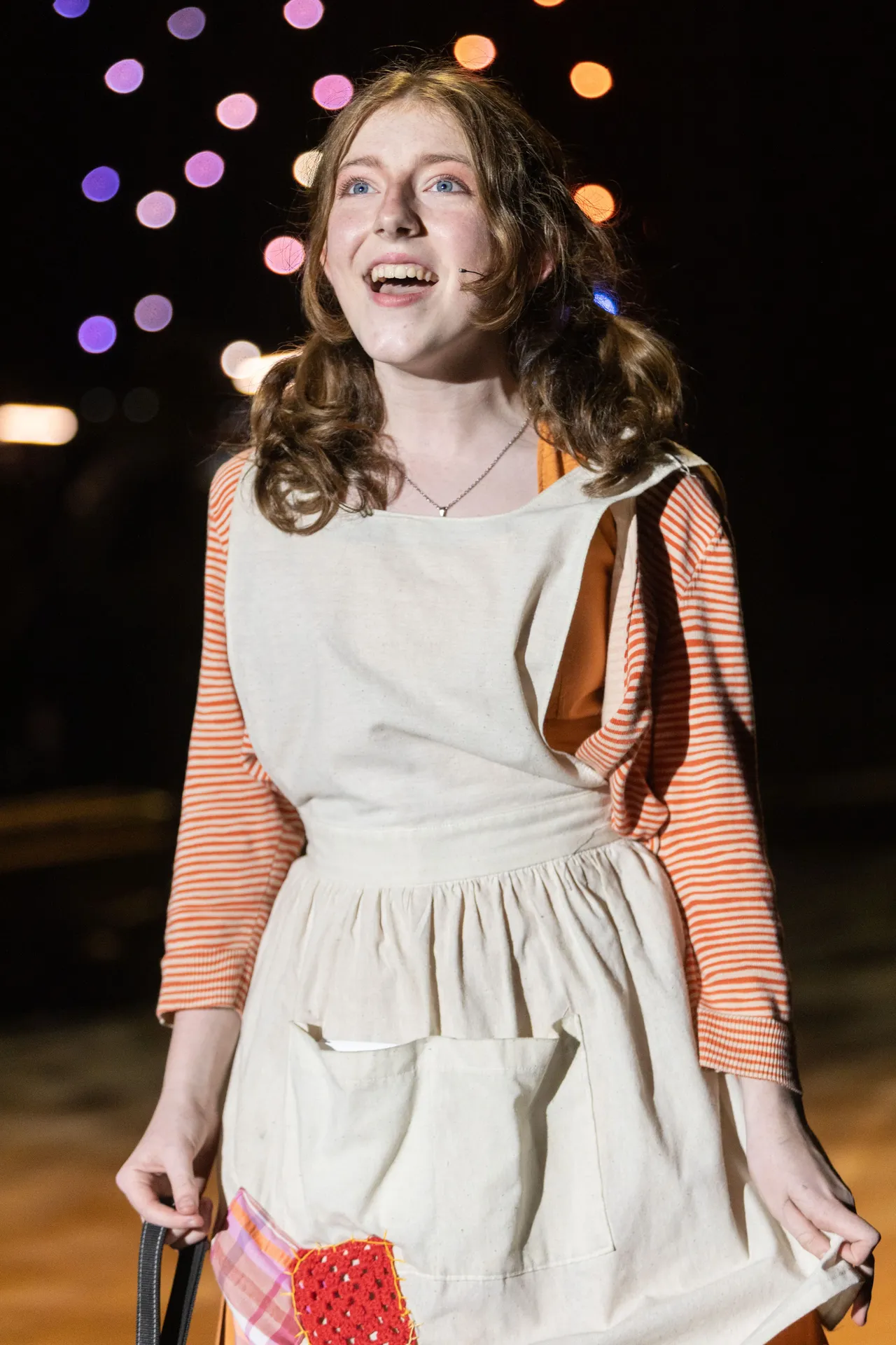 A St Michael's Grammar School student performs on stage in costume during a school musical production.