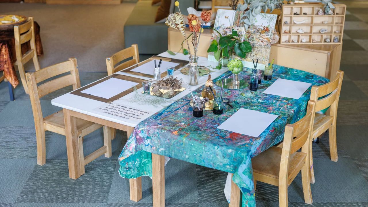 A beautifully prepared drawing provocation table in the St Michael's Grammar School ELC, set with blank paper, ink, natural specimens and fresh flowers to inspire mark-making and observation.