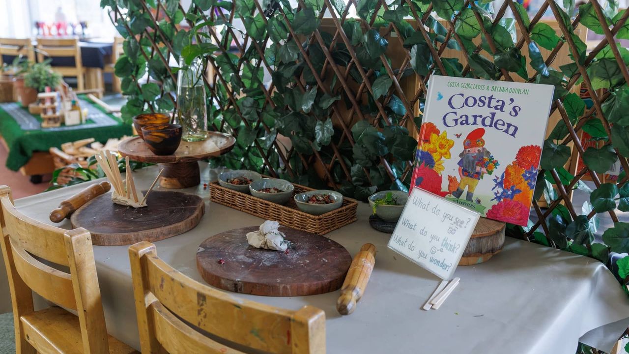 A nature-themed provocation table in the St Michael's Grammar School ELC, set up with clay, natural materials and the book Costa's Garden to inspire curiosity and inquiry-based learning.