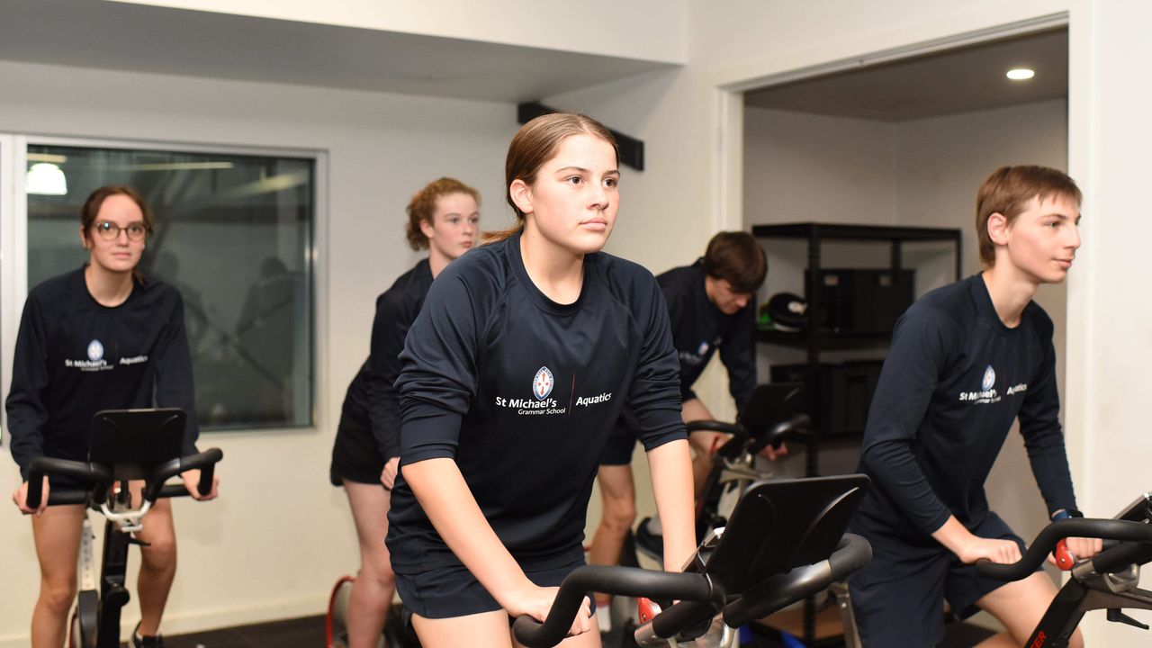 St Michael's Grammar School students use exercise bikes during a fitness session in the school's gymnasium.