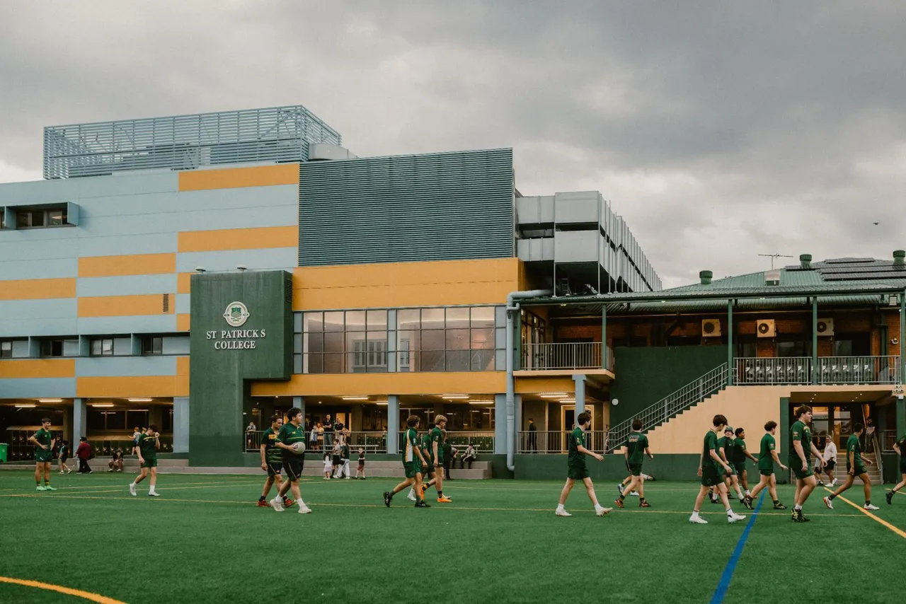 Students walking in front of the Back Oval