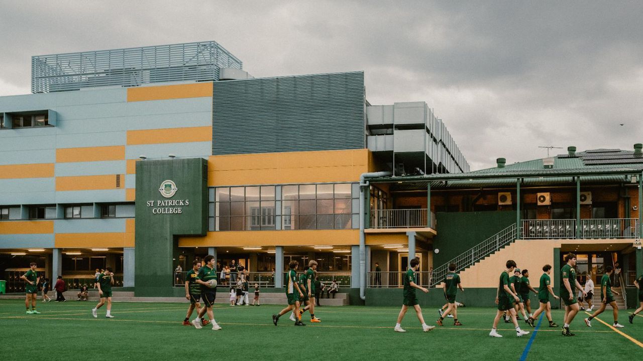 Students walking in front of the Back Oval